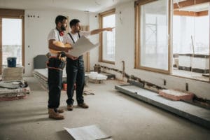 two workers renovating a home